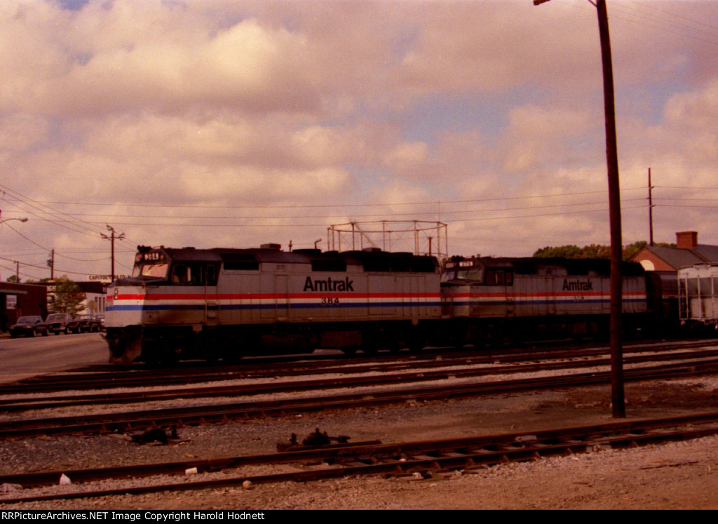 AMTK 384 & 379 lead a train away from the station